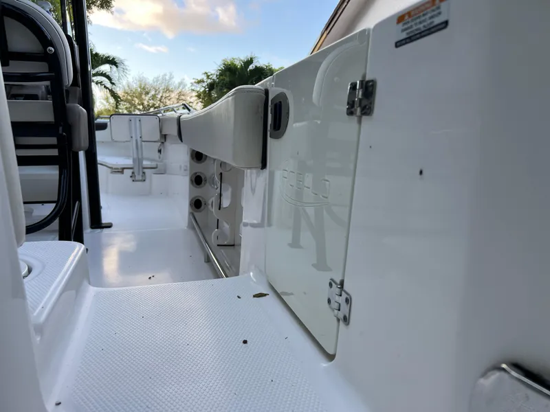 Slide: The Image of 2018 Robalo R242 Center Console boat interior, white deck and storage compartments. - 21