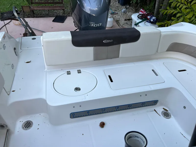 Slide: The Image of 2018 Robalo R242 Center Console boat deck with seating and storage compartments. - 23