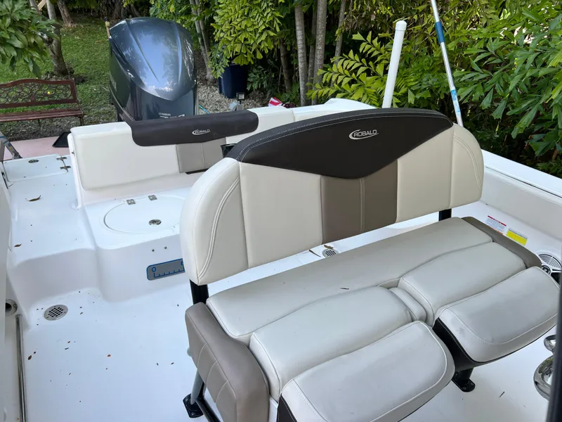 Slide: The Image of 2018 Robalo R242 Center Console boat interior with seating and outboard motor. - 25