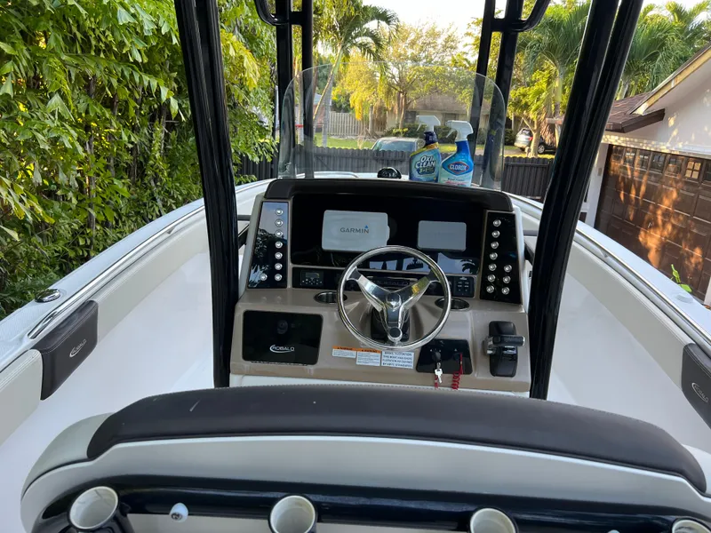 Slide: The Image of 2018 Robalo R242 Center Console boat cockpit with steering wheel and navigation equipment. - 28