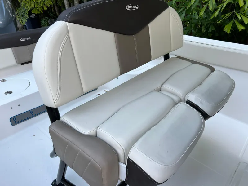 Slide: The Image of 2018 Robalo R242 Center Console boat seating with cushioned backrest and armrests. - 30