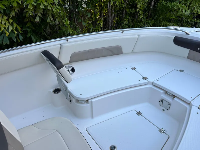 Slide: The Image of 2018 Robalo R242 Center Console boat interior with white seating and storage compartments. - 33
