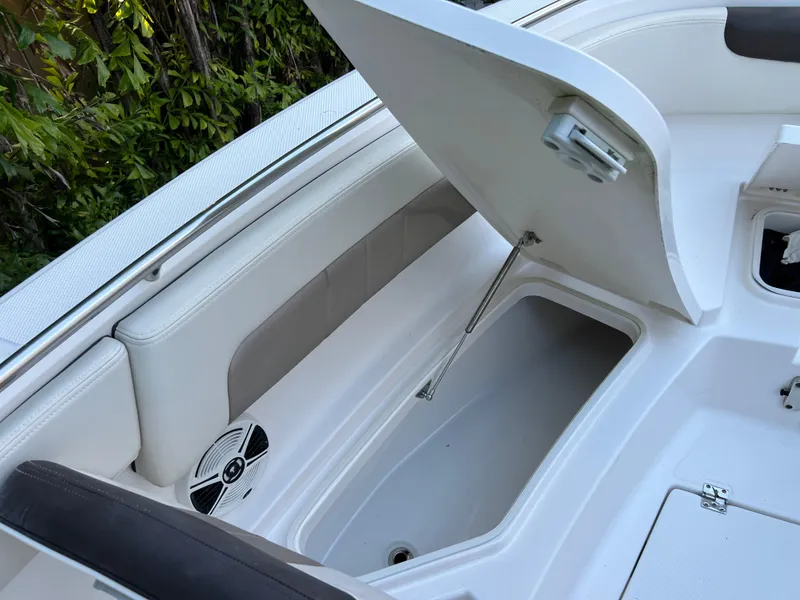 Slide: The Image of 2018 Robalo R242 Center Console boat with open storage compartment. - 35