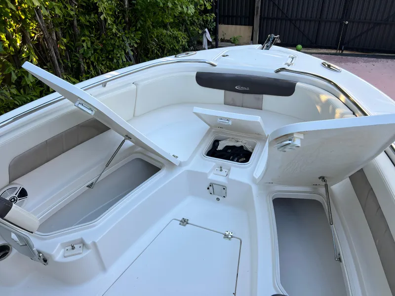 Slide: The Image of 2018 Robalo R242 Center Console boat with open storage compartments. - 36