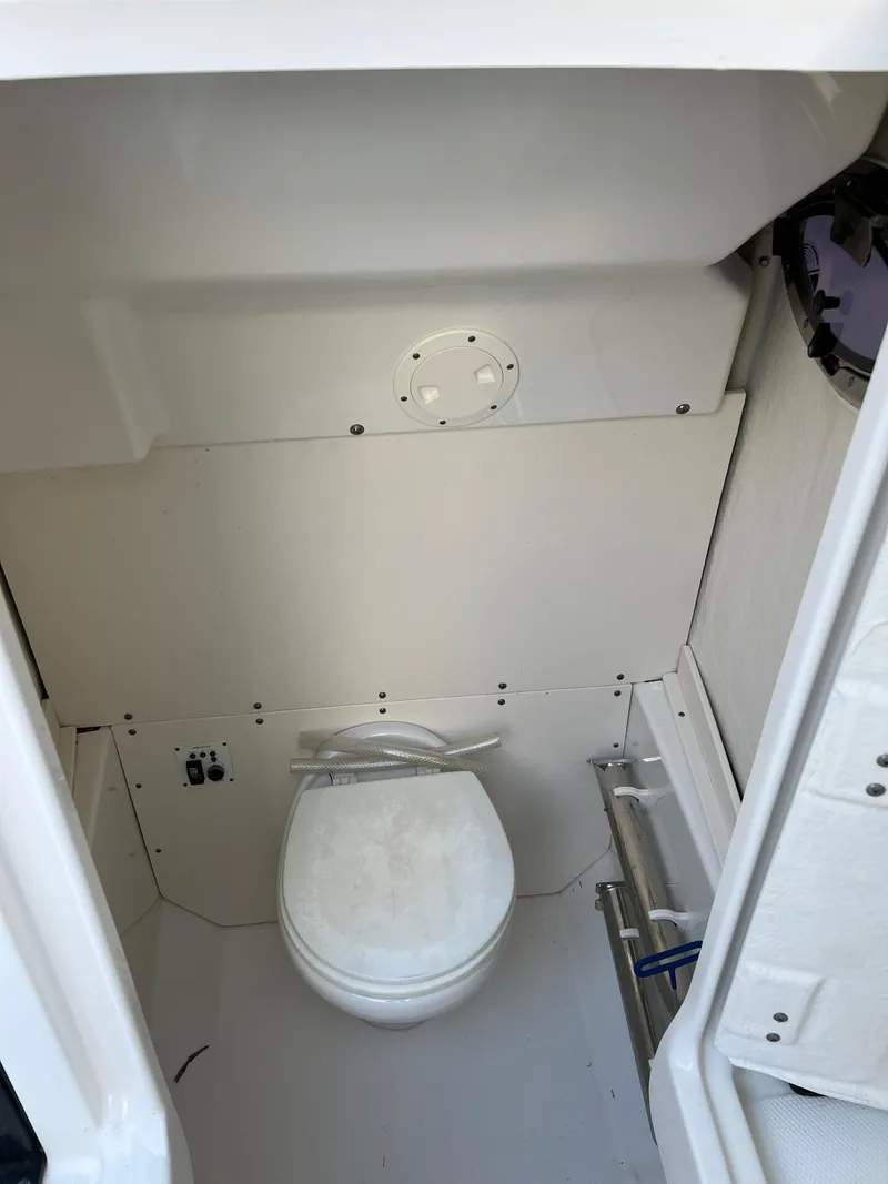 Slide: The Image of 2018 Robalo R242 Center Console boat interior with marine toilet. - 42