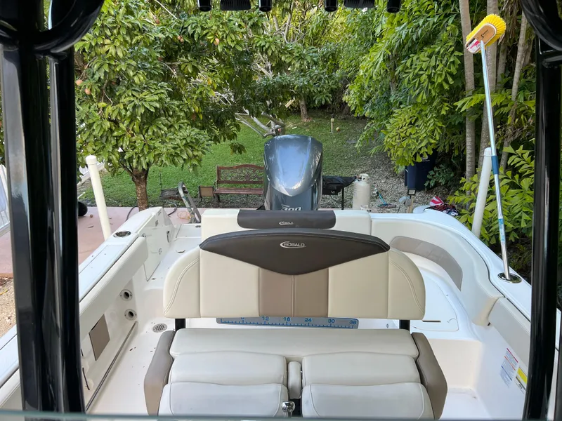 Slide: The Image of 2018 Robalo R242 Center Console boat with seating and outboard motor. - 44