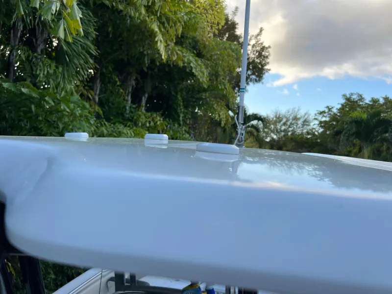 Slide: The Image of 2018 Robalo R242 Center Console boat top view with lush greenery in the background. - 49