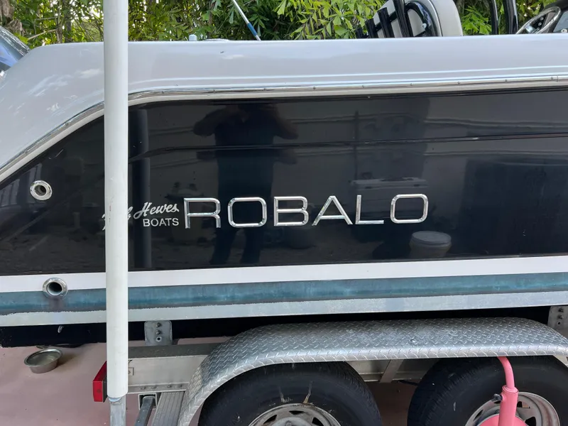 Slide: The Image of 2018 Robalo R242 Center Console boat on a trailer. - 9