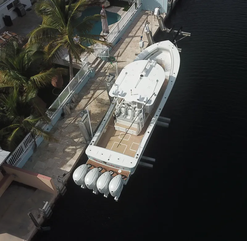 Slide: The Image of Aerial view of 2022 Regulator 41 boat docked by a waterfront home. - 1