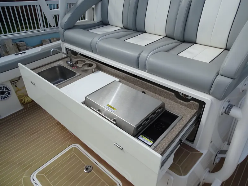 Slide: The Image of 2022 Regulator 41 boat with outdoor kitchen, featuring grill and sink. - 17