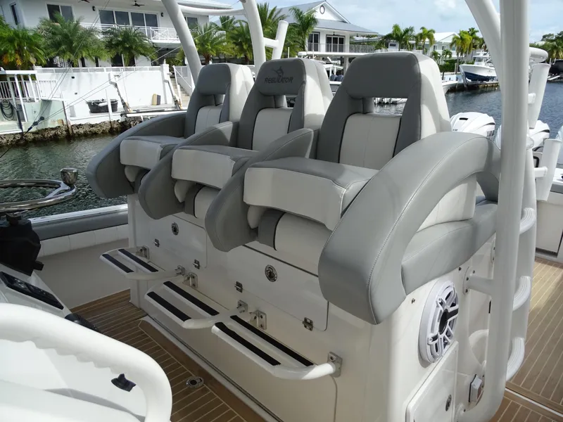 Slide: The Image of Luxury seating on 2022 Regulator 41 boat, featuring plush gray and white upholstery. - 18