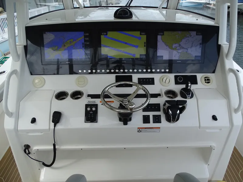 Slide: The Image of 2022 Regulator 41 boat dashboard with advanced navigation screens and controls. - 21