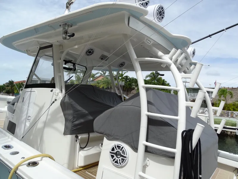 Slide: The Image of 2022 Regulator 41 boat with covered seating and fishing equipment. - 22