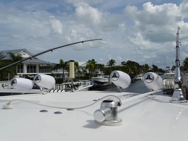 Slide: The Image of 2022 Regulator 41 boat docked in a scenic marina with cloudy sky. - 28