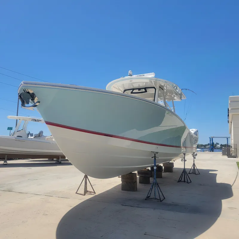 Slide: The Image of 2022 Regulator 41 boat on stands under clear blue sky. - 39