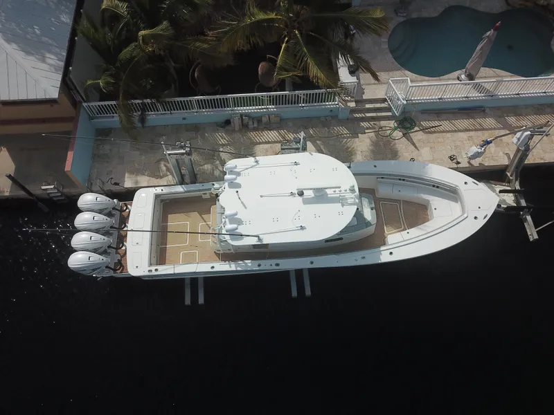 Slide: The Image of Aerial view of 2022 Regulator 41 boat docked near a poolside patio. - 5