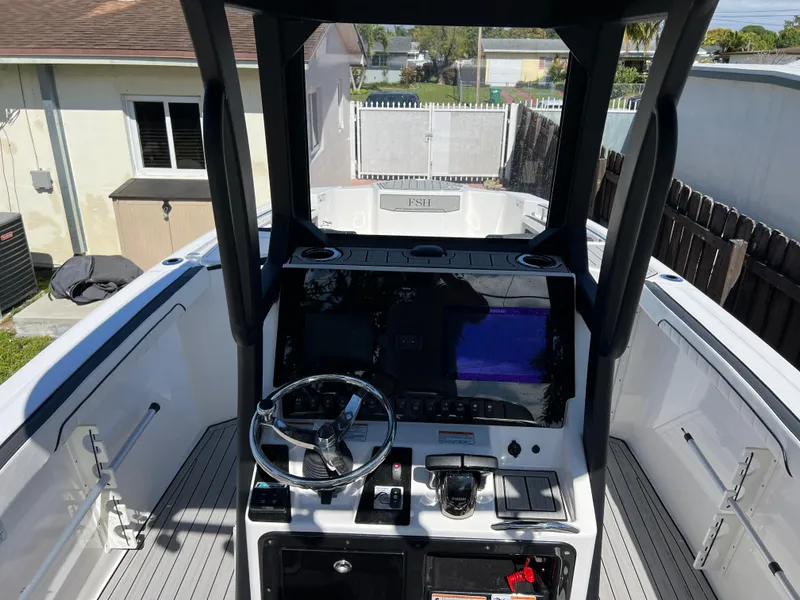 Slide: The Image of 2021 Yamaha Boats FSH 255 Sport E cockpit with steering wheel and control panel. - 12