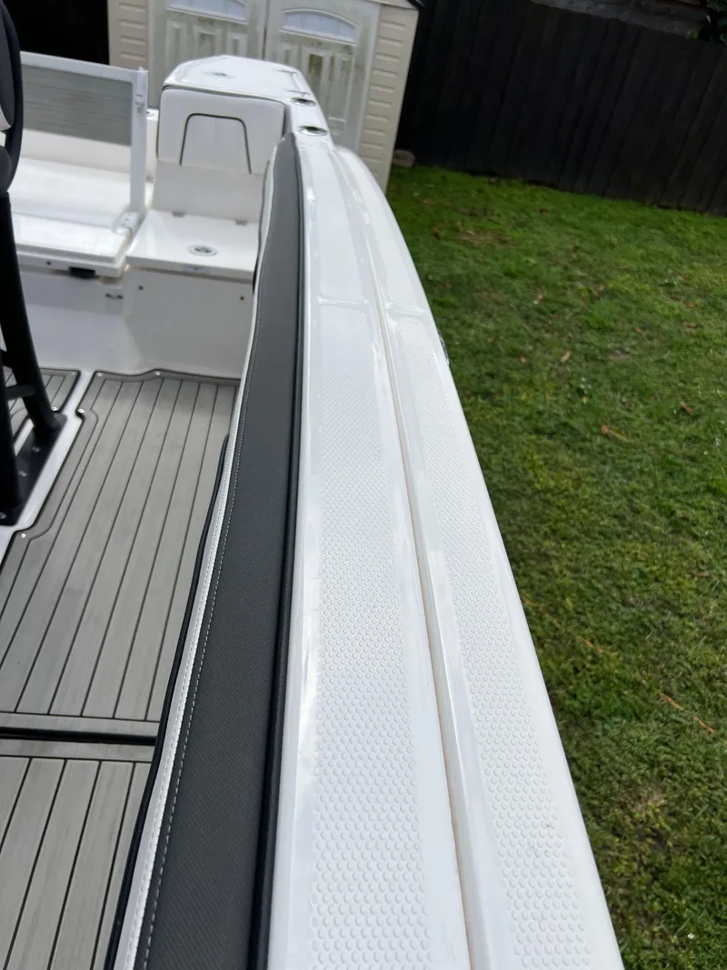 Slide: The Image of 2021 Yamaha Boats FSH 255 Sport E deck view with seating and flooring. - 19