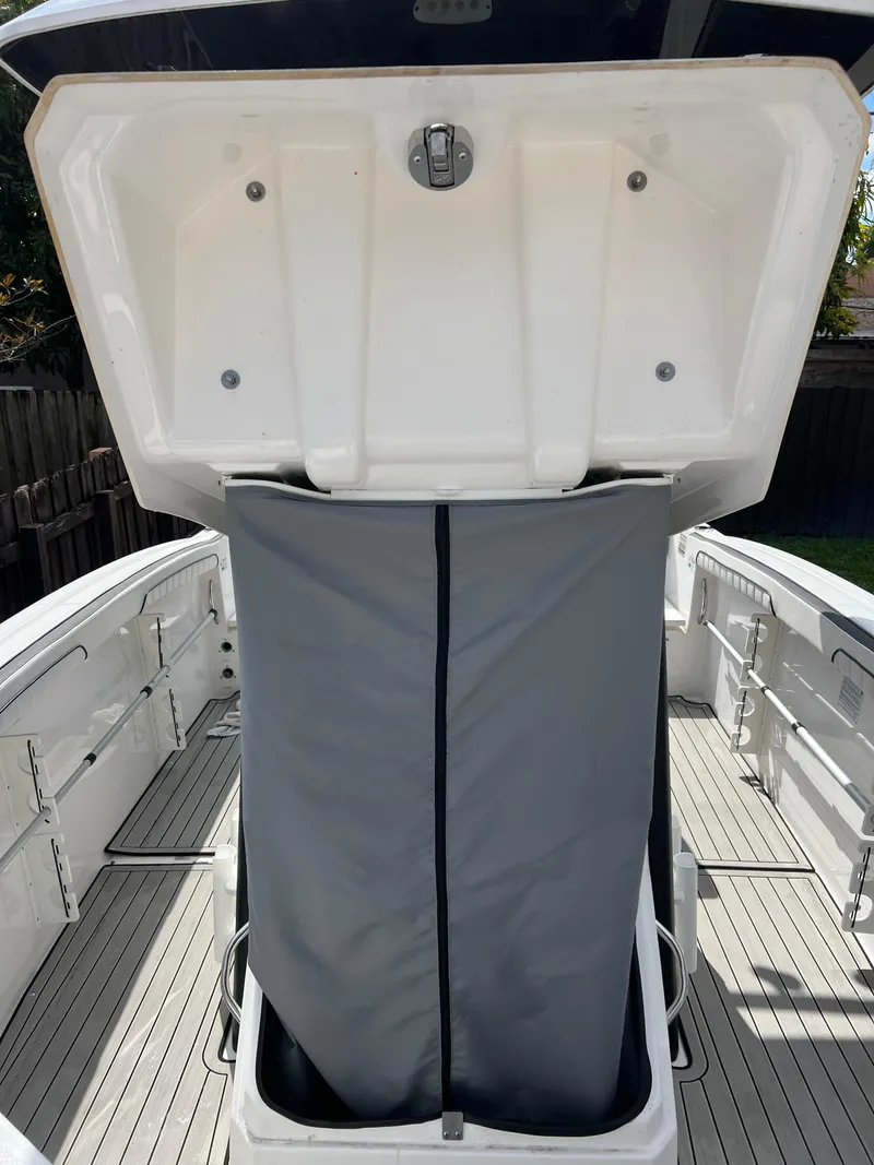 Slide: The Image of 2021 Yamaha Boats FSH 255 Sport E storage compartment with open lid. - 25