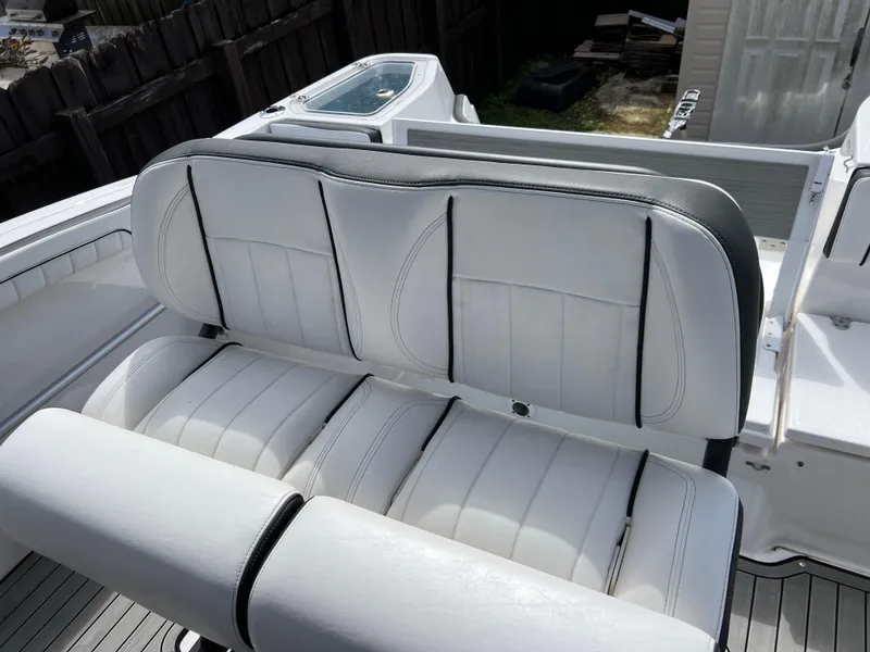 Slide: The Image of 2021 Yamaha Boats FSH 255 Sport E, white leather seating, rear view. - 30