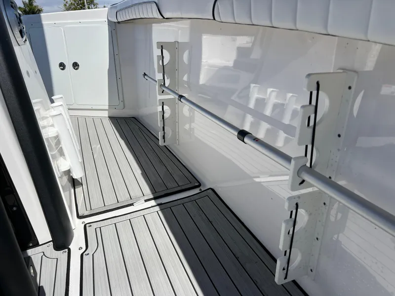 Slide: The Image of 2021 Yamaha Boats FSH 255 Sport E interior with rod holders and non-slip flooring. - 9