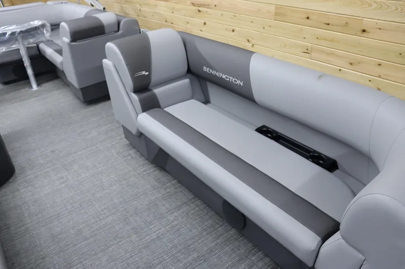 Slide: The Image of 2024 Bennington 22SVL pontoon boat interior with gray and black seating. - 10