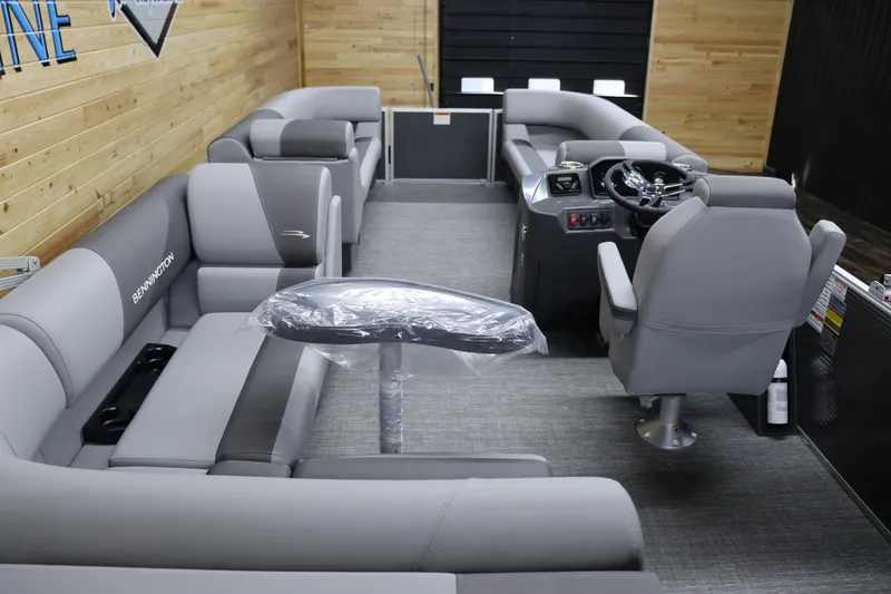Slide: The Image of 2024 Bennington 22SVL pontoon boat interior with grey seating and captain's chair. - 15