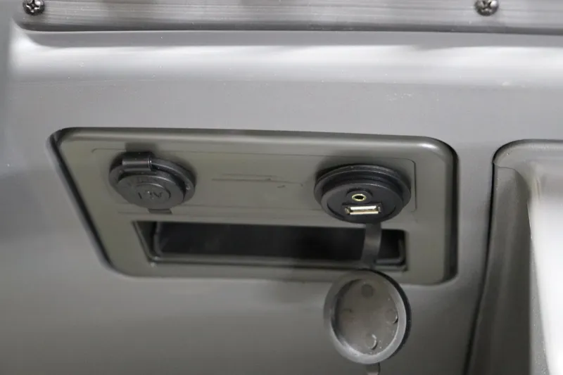 Slide: The Image of 2024 Bennington 22SVL boat dashboard with USB and 12V power outlets. - 21