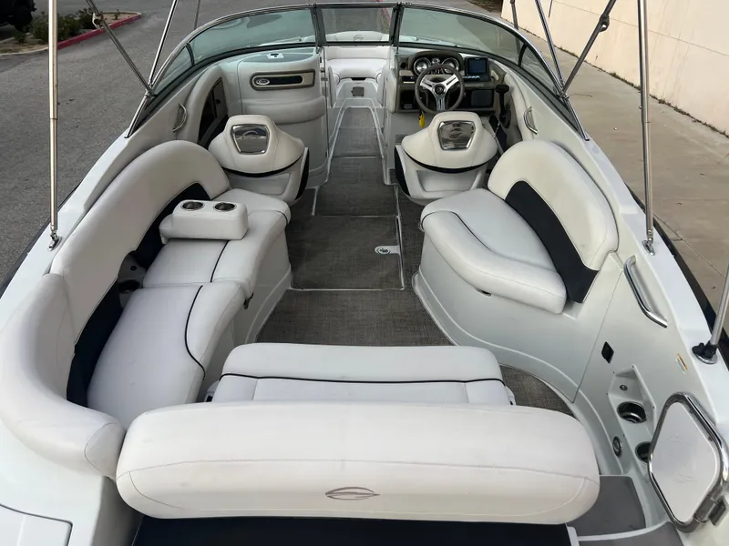 Slide: The Image of 2016 Crownline 270 SS boat interior with white leather seating and modern dashboard. - 10