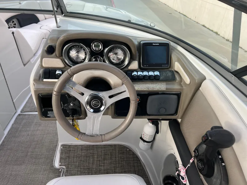 Slide: The Image of 2016 Crownline 270 SS boat dashboard with steering wheel and control panel. - 11