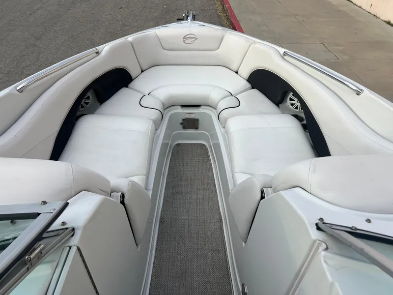 Slide: The Image of 2016 Crownline 270 SS boat interior with white seating and carpeted floor. - 14
