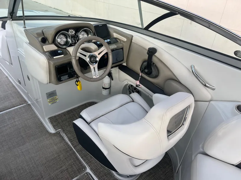 Slide: The Image of 2016 Crownline 270 SS boat cockpit with steering wheel and control panel. - 34