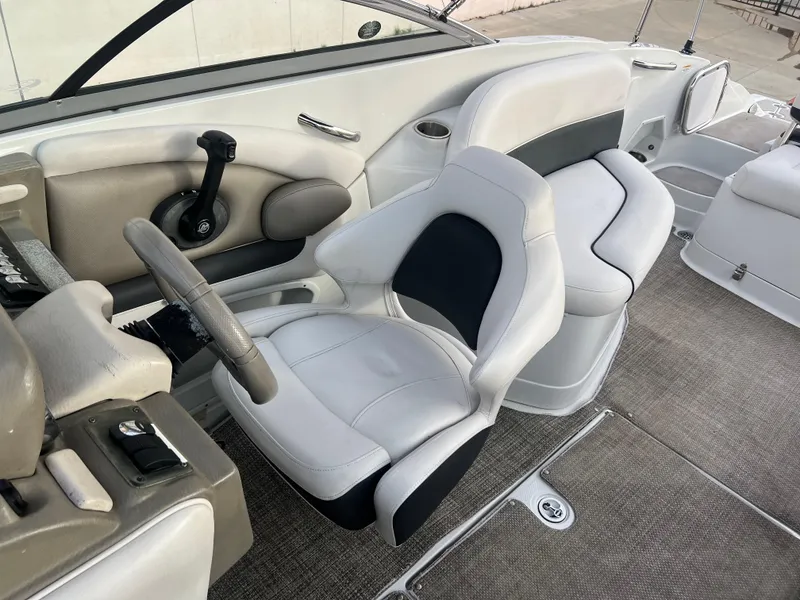 Slide: The Image of 2016 Crownline 270 SS boat interior with captain's chair and steering wheel. - 41
