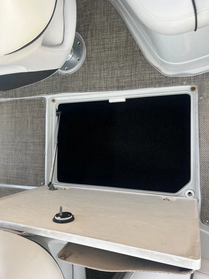 Slide: The Image of 2016 Crownline 270 SS storage compartment with open hatch. - 43