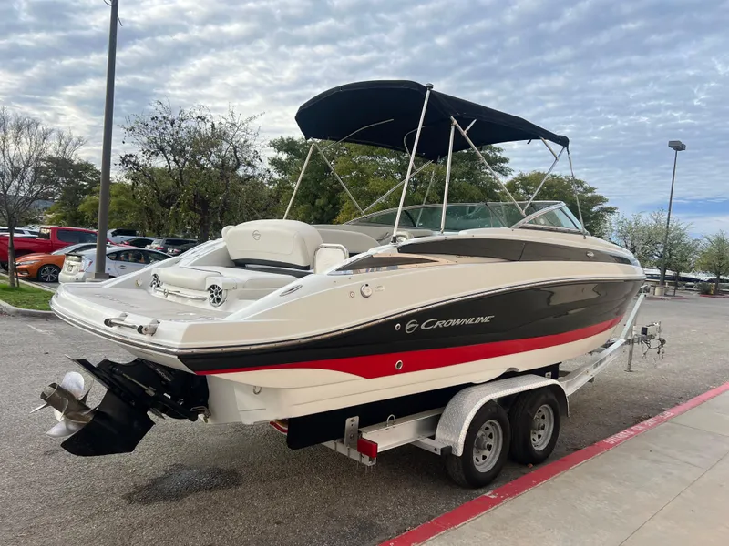 Slide: The Image of 2016 Crownline 270 SS boat on a trailer with a black canopy. - 6