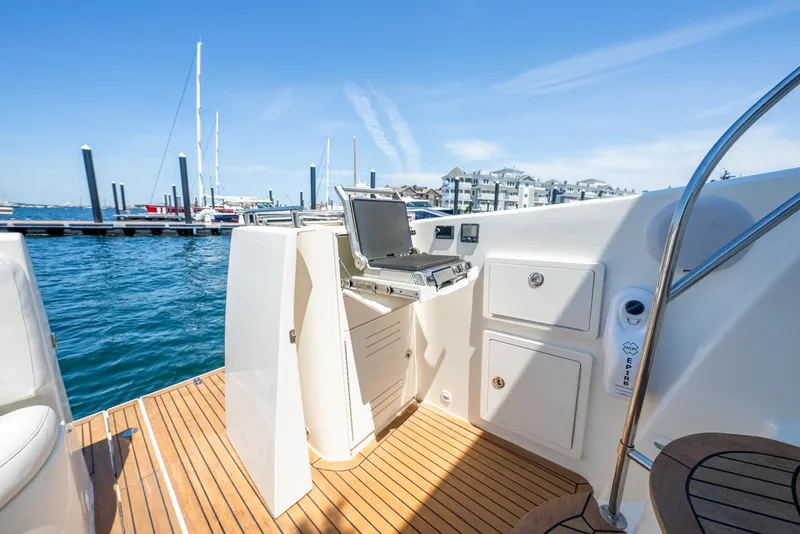 Slide: The Image of 2004 Meridian 459 Motor Yacht deck with grill and storage, docked at marina. - 13