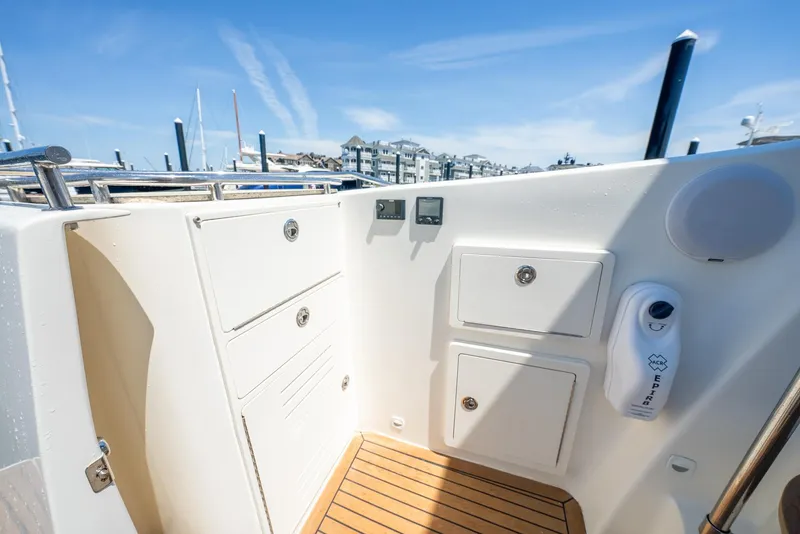 Slide: The Image of 2004 Meridian 459 Motor Yacht deck with storage compartments and teak flooring. - 15