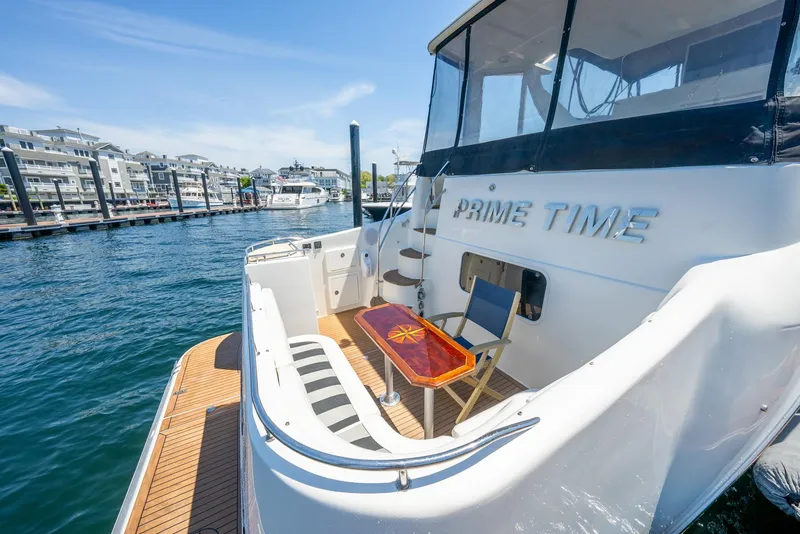 Slide: The Image of 2004 Meridian 459 Motor Yacht docked, featuring spacious deck and seating area. - 18