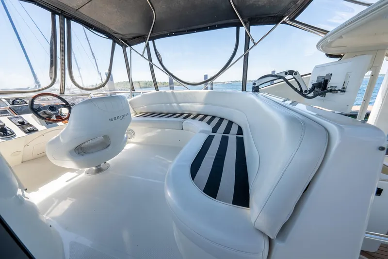 Slide: The Image of Interior of 2004 Meridian 459 Motor Yacht with white seating and panoramic windows. - 21