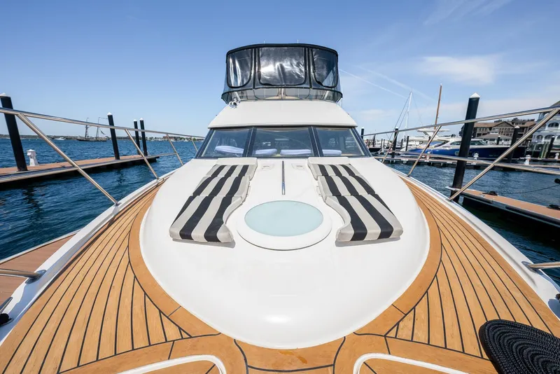 Slide: The Image of 2004 Meridian 459 Motor Yacht docked, featuring spacious deck and sun loungers. - 26