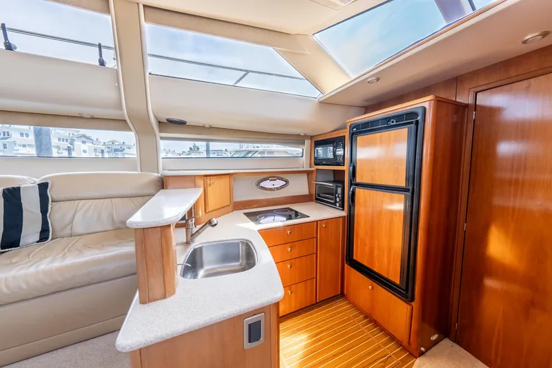 Slide: The Image of 2004 Meridian 459 Motor Yacht interior with kitchen and seating area. - 28