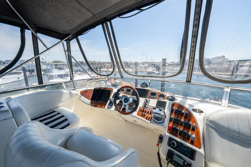 Slide: The Image of 2004 Meridian 459 Motor Yacht helm with panoramic marina view. - 4