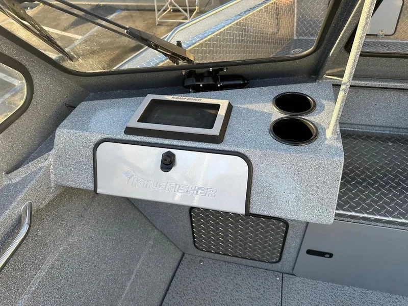 Slide: The Image of Interior of 2024 KingFisher 2025 Falcon boat with dashboard and cup holders. - 14