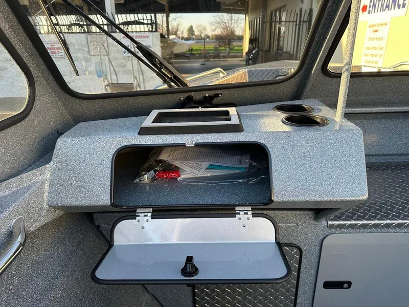 Slide: The Image of Dashboard of 2024 KingFisher 2025 Falcon boat with storage compartment and cup holders. - 15