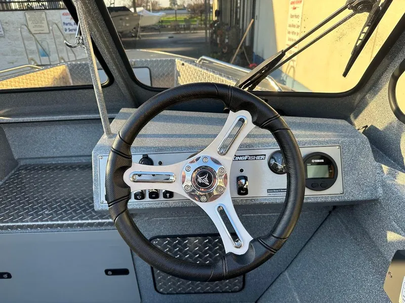 Slide: The Image of Steering wheel of 2024 KingFisher 2025 Falcon boat, featuring modern dashboard controls. - 17