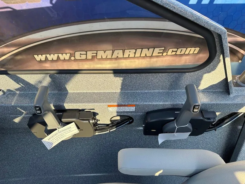 Slide: The Image of Interior of 2024 KingFisher 2025 Falcon boat with control levers and GFMarine.com branding. - 20