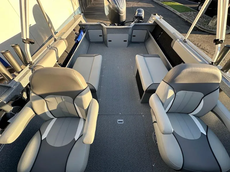 Slide: The Image of 2024 KingFisher 2025 Falcon boat interior with seating and motor. - 21