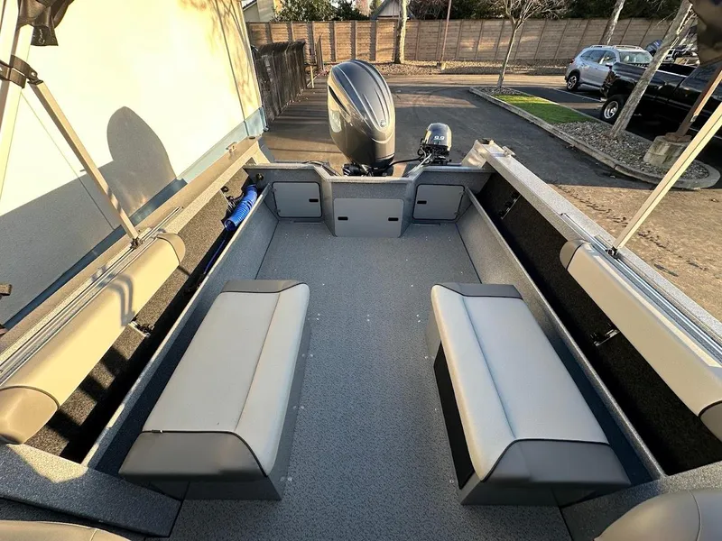 Slide: The Image of 2024 KingFisher 2025 Falcon boat interior with seating and outboard motor. - 22