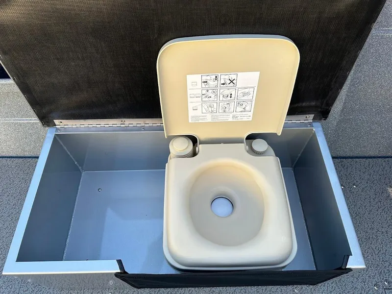 Slide: The Image of Portable toilet in KingFisher 2025 Falcon, 2024 model, with open lid and instructions. - 27