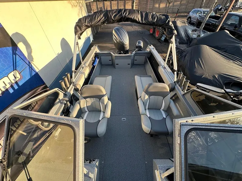 Slide: The Image of KingFisher 2025 Falcon boat interior with seating and motor, 2024 model. - 36